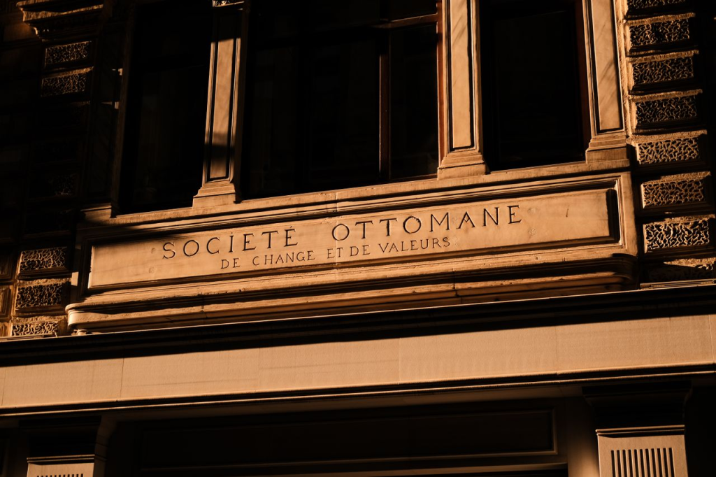 Close-up of a historical building facade with 'Société Ottomane' engravings.